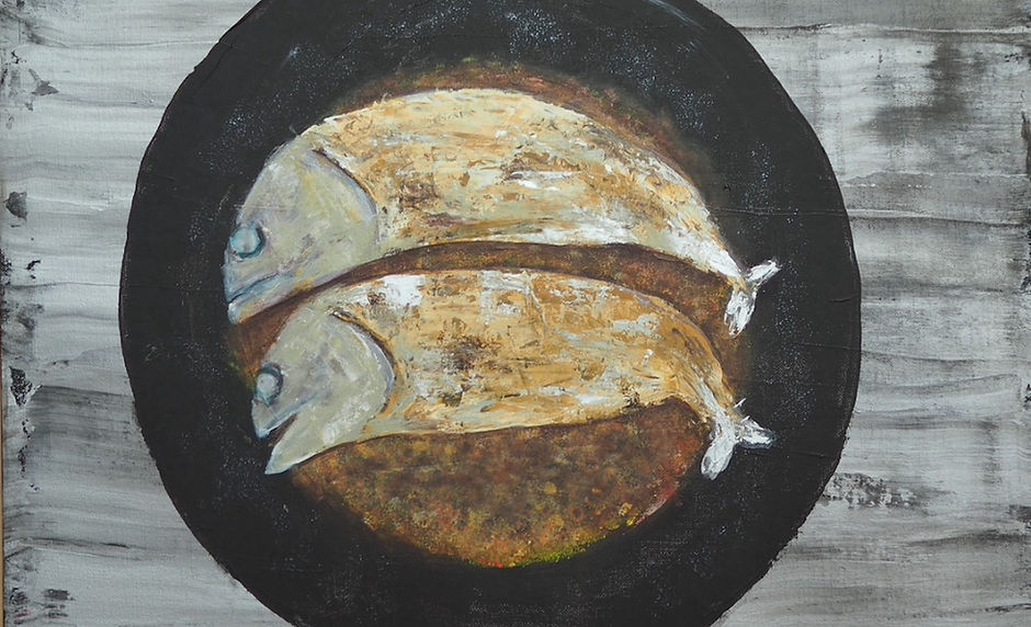Two fried fish in a pan