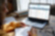 A woman uses a laptop to search for a meeting in Pathminder Meetings.