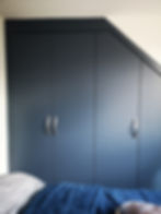 Wardrobe fitted to irregular-shaped ceiling