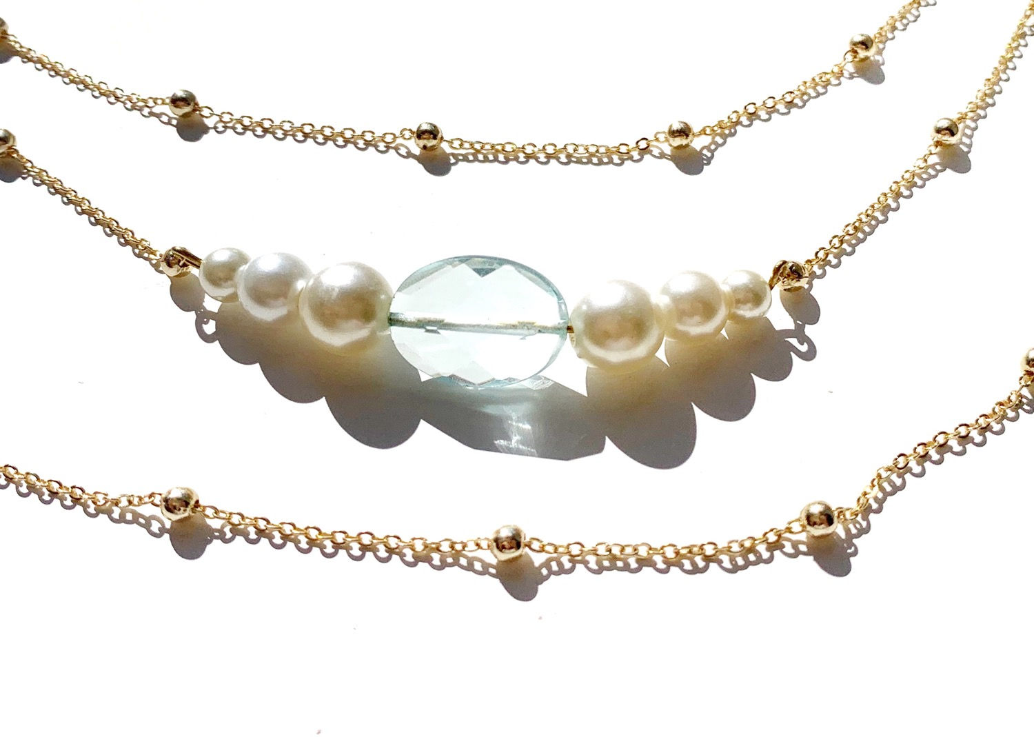 Dainty gold multi-strand pearl choker necklace with white faux pearl detail