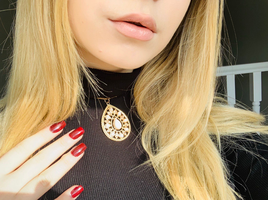 Boho style gold chain choker necklace with a gold pendant with pink crystals