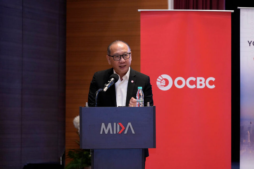 MIDA and OCBC Malaysia representatives signing a strategic partnership to attract high-value investment and support Malaysian SMEs.