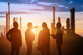 Silhouette of Teams engineer and foreman working at petrochemical oil refinery in sunset.j