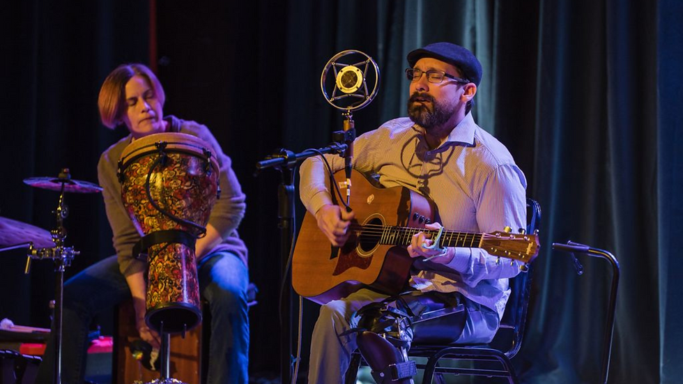 Two musicians perform at White Horse Black Mountain during the March 4th Celebration event, supporting the local community fund.