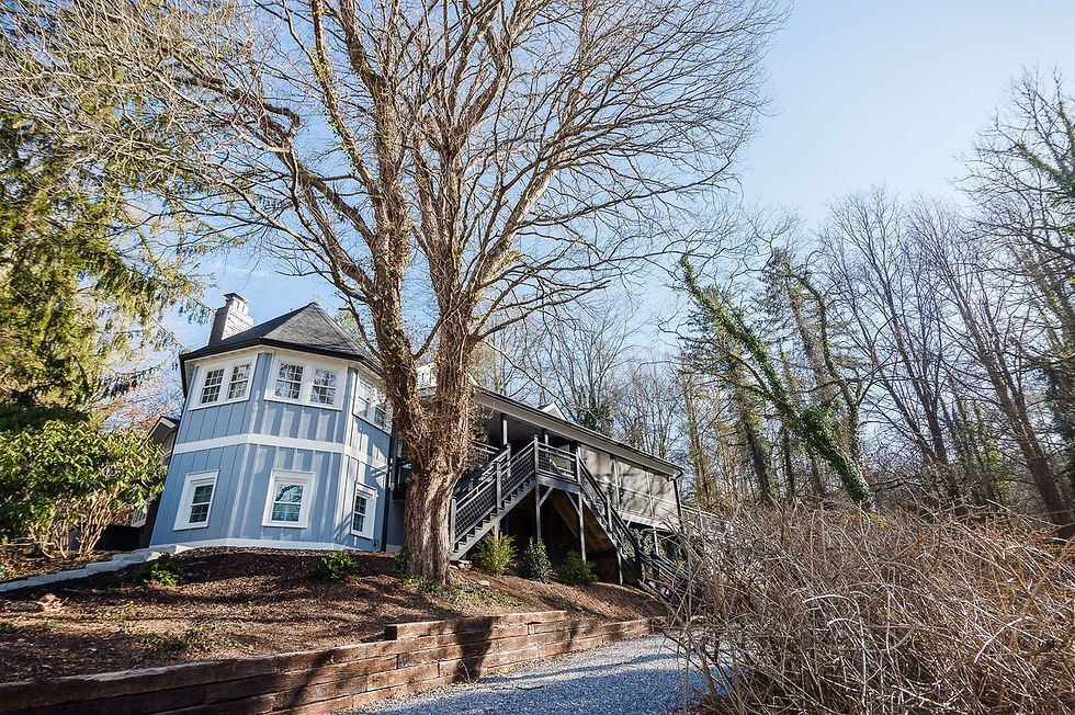 The restored Tower Room, affixed to the original structure, its exterior stairway threading between garden, hill, and main living level.