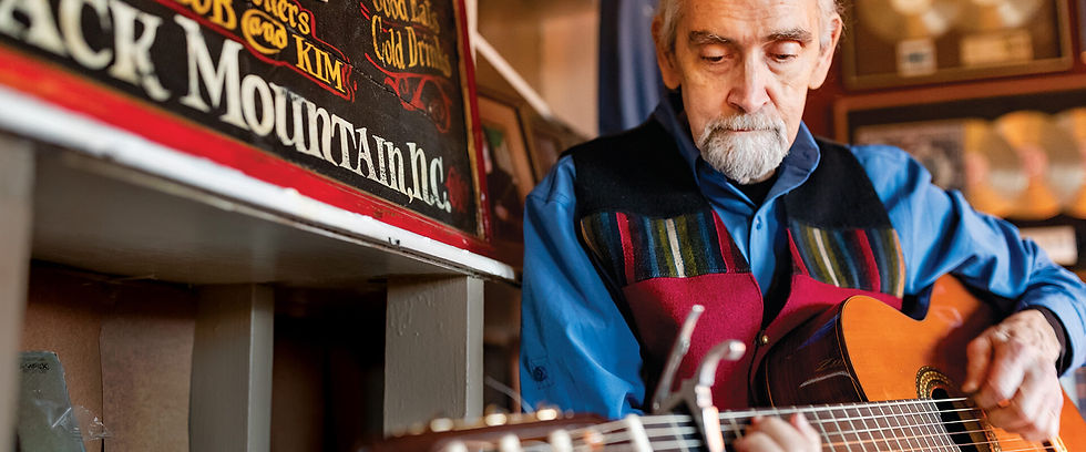White Horse Black Mountain co-founder Bob Hinkle performs on stage, bringing decades of music industry experience to the venue.