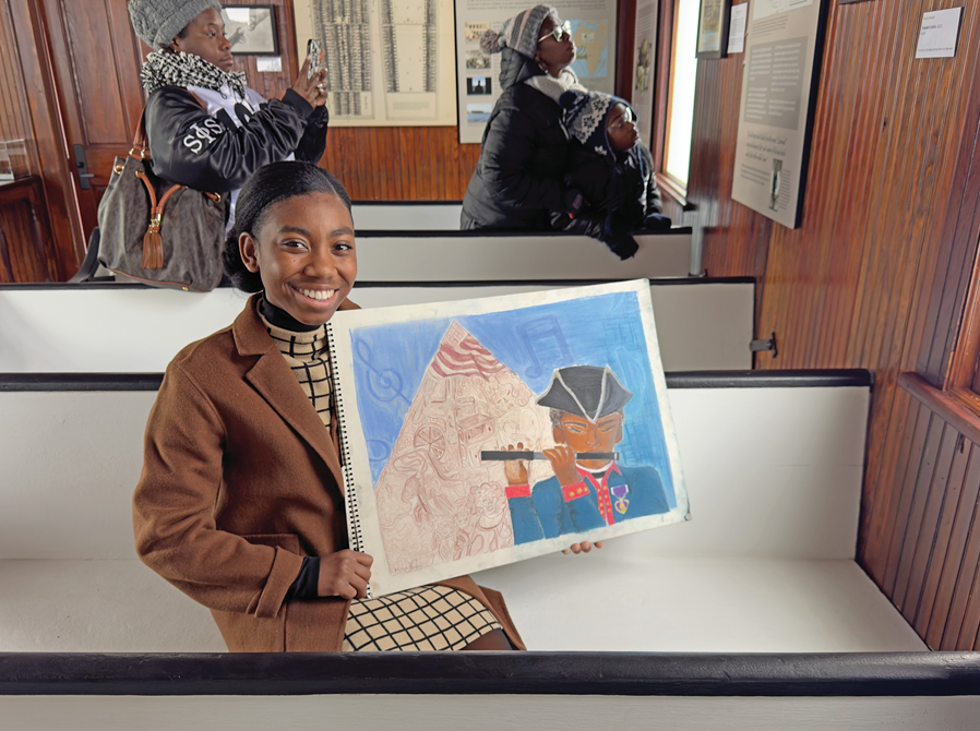 Maya Bailey, a sophomore at Montgomery High School, at SSAAM on Martin Luther King Day sharing an art project she completed titled, “William Stives, The Fife Player: His Soil, America’s Story.”