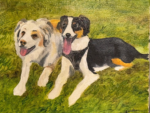 Two Dogs Laying In The Grass.jpeg