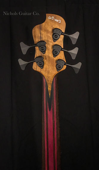 Persimmon bass guitar with colorful wood laminations
