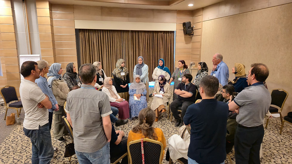 A group of around 30 people in concentric circles talking