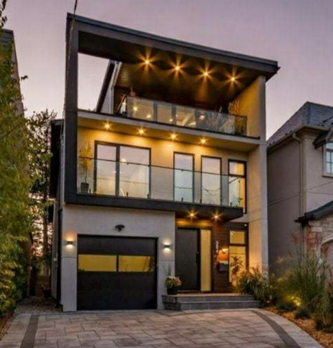 Street-view photo of the completed Ellis Ave modern home with wood and glass exterior.
