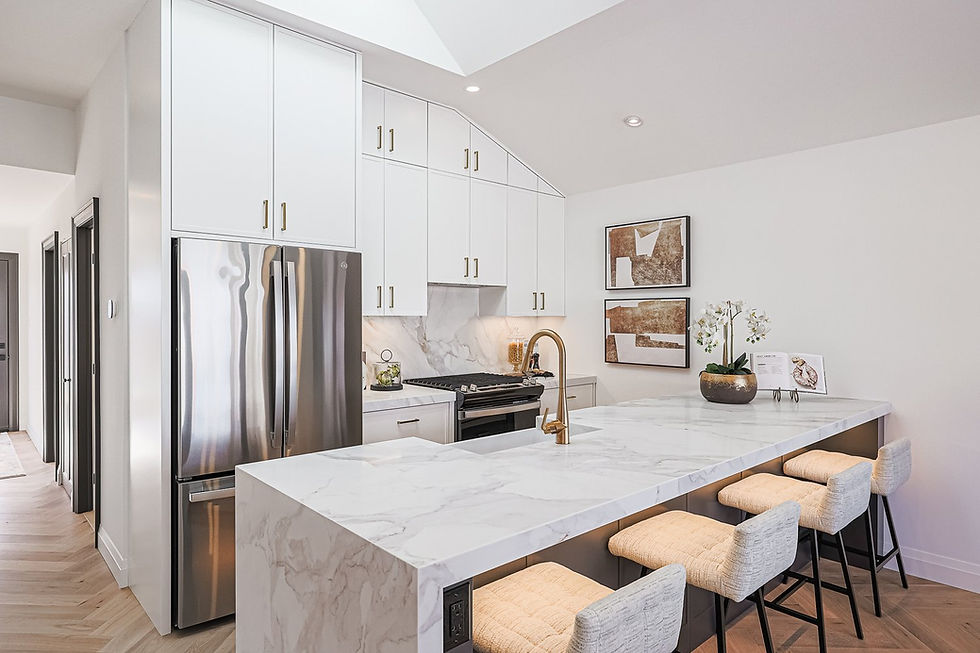Modern kitchen with a sleek marble countertop, matching bar stools, and stainless steel appliances, featuring minimalist white cabinetry and elegant gold accents.