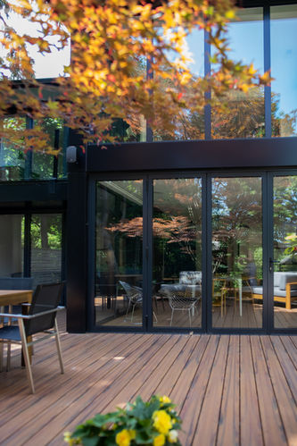 Completed Forest Hill rear addition with full-height glass pavilion and black framing.