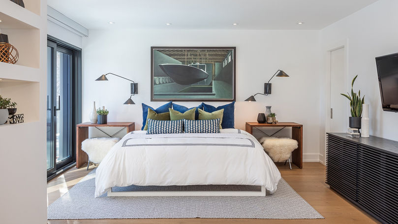 Primary bedroom with large windows, modern millwork, and minimalist decor in a Forest Hill home.