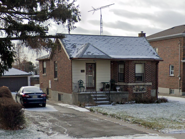 Original one-storey brick bungalow on Rustic Dr in Toronto before the second-floor addition project.