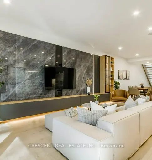 Modern living room with feature wall and open flow to kitchen on Ellis Ave ground floor.