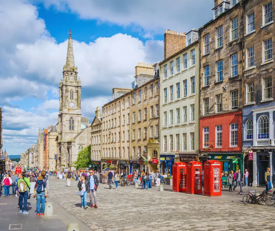 Historic buildings along the Royal Mile with red phone boxes and cobblestone streets