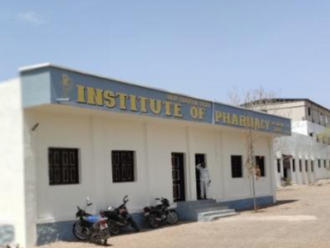A white building labeled "Institute of Pharmacy" with parked motorcycles outside. A person stands at the entrance. Clear blue sky above.
