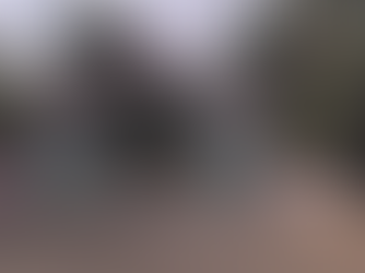 Entrance of J.T. Mahajan College of Engineering, Faizpur, with a pink and blue archway. Surrounding palm trees and clear sky define the setting.