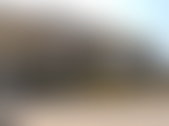 Yellow buses parked in front of a large beige building with MATS University signage, featuring columns and a paved courtyard.