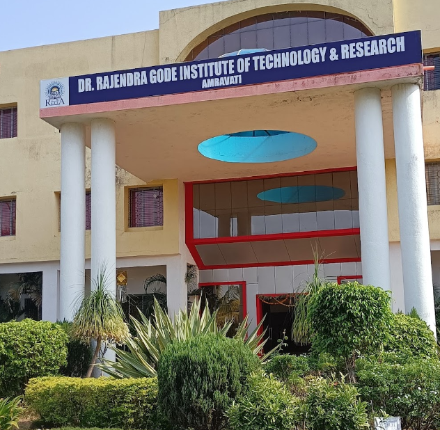 Entrance of Dr. Rajendra Gode Institute of Technology & Research, Amravati. Cream building with red accents, lush green plants, and clear sky.