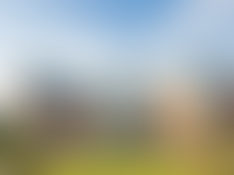 Modern building of Dr. D.Y. Patil Institute of Technology with red brick and glass facade, surrounded by greenery. People walk on pathways.