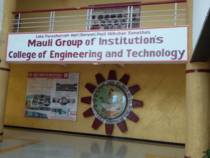 Sign for Mauli Group of Institution's College of Engineering and Technology on a yellow wall, with posters and a circular logo displayed.