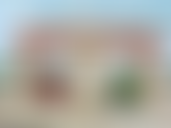 Entrance gate of P.R. Pote Patil Group of Educational Institutes, Amravati, with two people on a motorcycle entering. Bright, clear day.