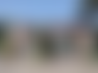 Entrance of a college with an archway reading "Devagiri Mahavidyalaya Aurangabad." People walk under a blue sky with greenery around.