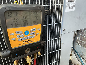 beede ac checking gauges on condenser outside