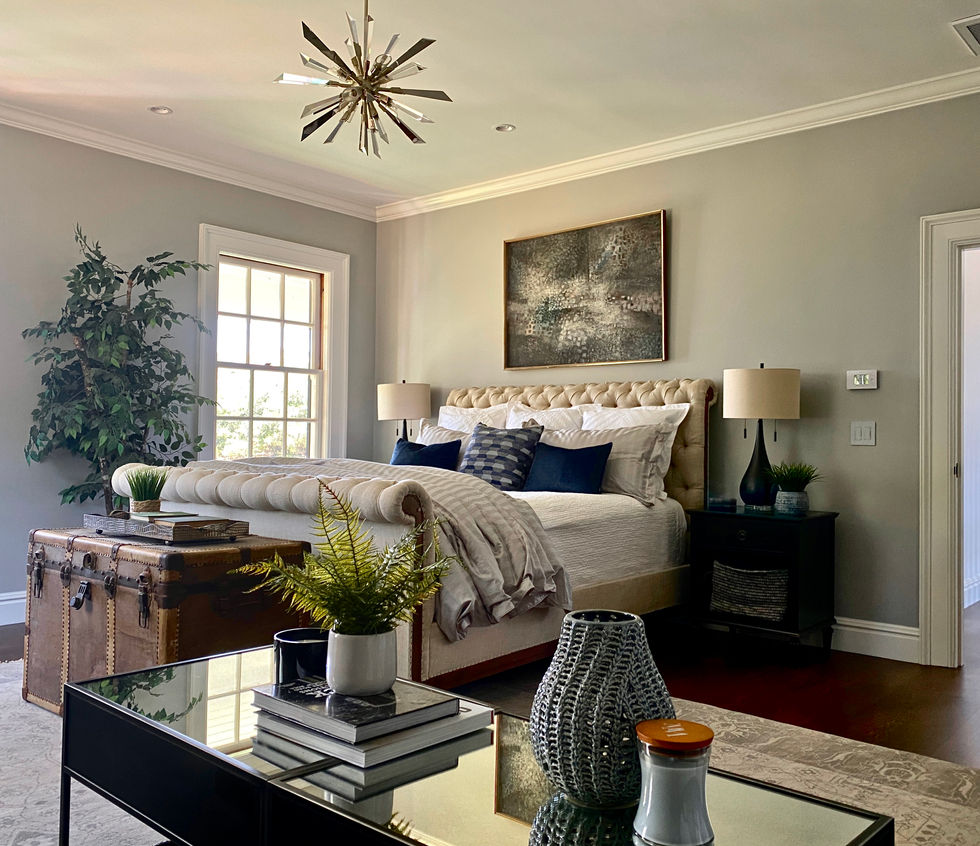 Traditional masculine bedroom design with tufted upholstered bed.