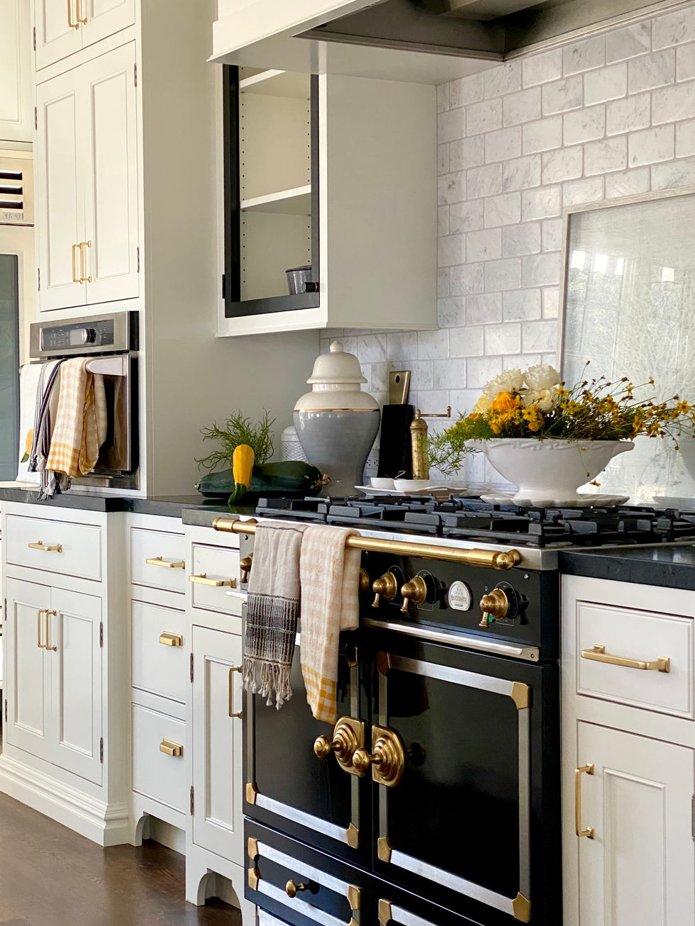 La Cornue black range in white modern farm kitchen design.
