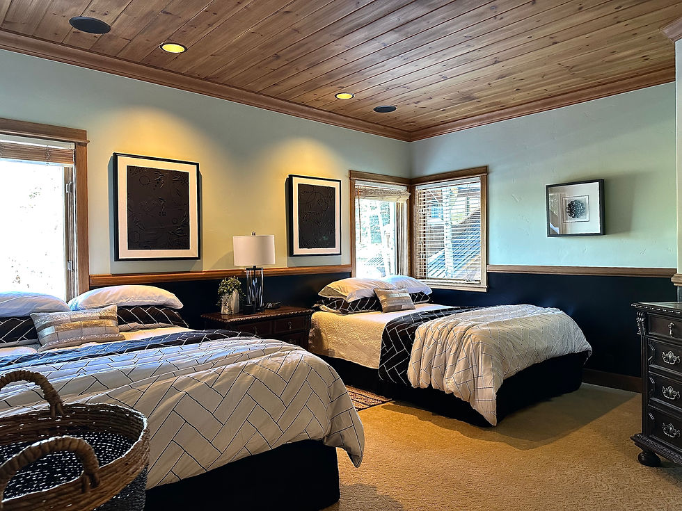 Guest bedroom makeover with two queen beds, new black and white bedding, black painted walls, modern art, modern black lamp.