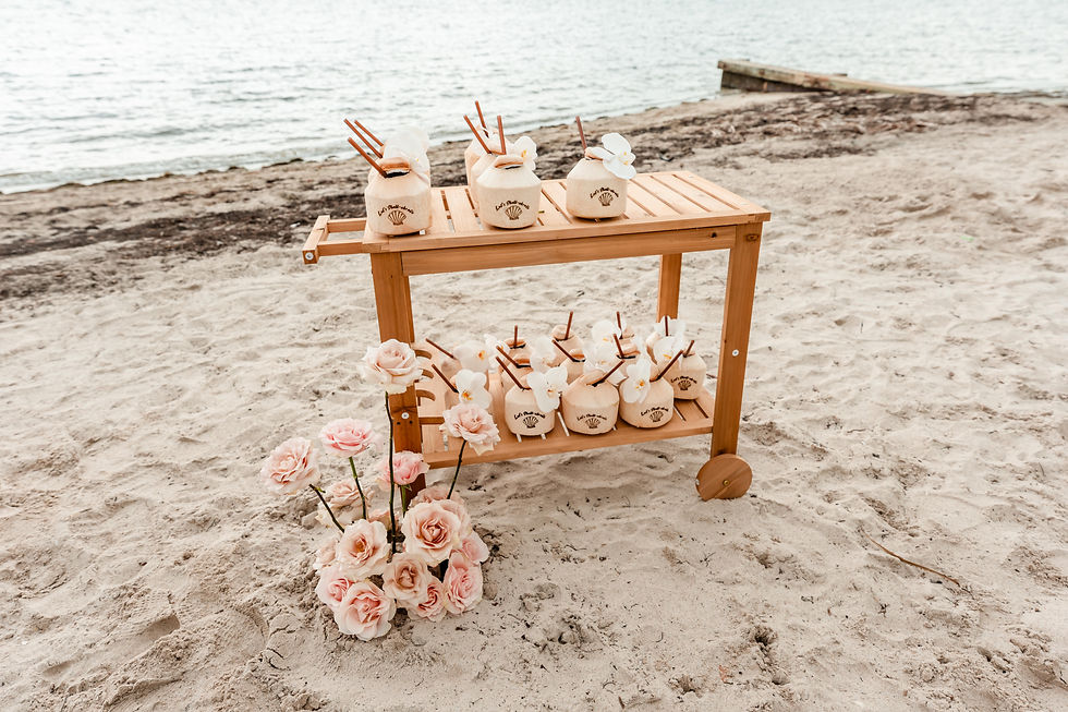 Guests were greeted with fresh coconuts personalized for the celebration and decorated with orchids, creating a tropical welcome that perfectly matched the beach setting.