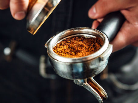 Barista holding portafilter and coffee tamper