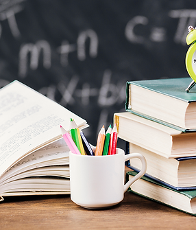 clock-on-top-of-textbooks-at-teacher-desk_0.25x.png