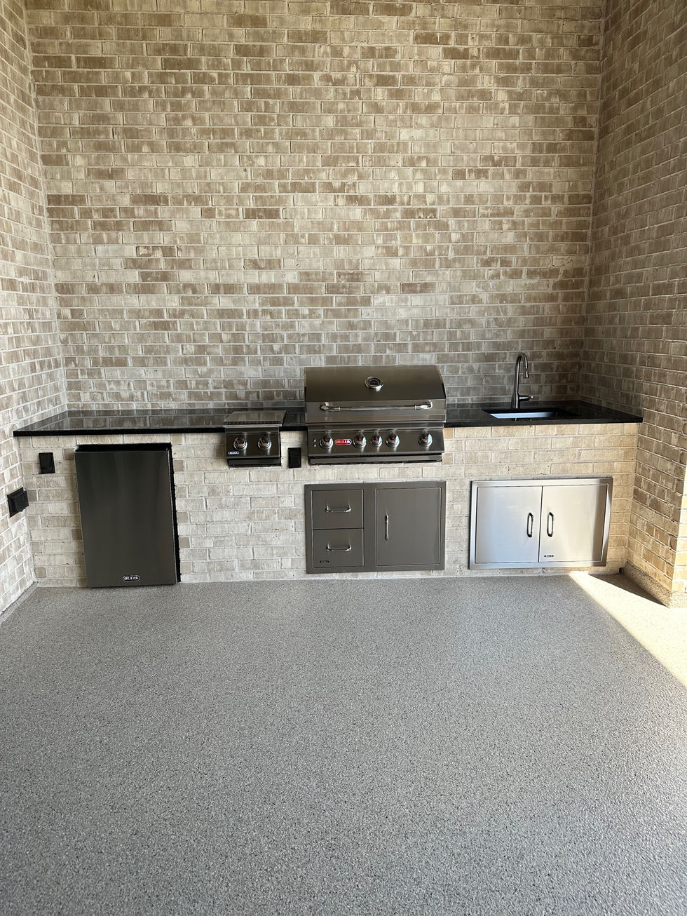 Custom Outdoor Kitchen with Stainless Steel Appliances and Granite Countertop