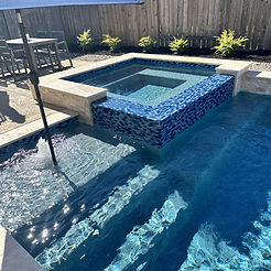 Custom Pool with Bubbler and  pa Corner Spillway in Summer in Richmond, TX