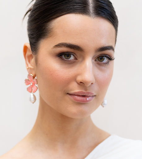 Soft glam eye makeup and natural skin bridal makeup and sleek bridal bun on brown hair