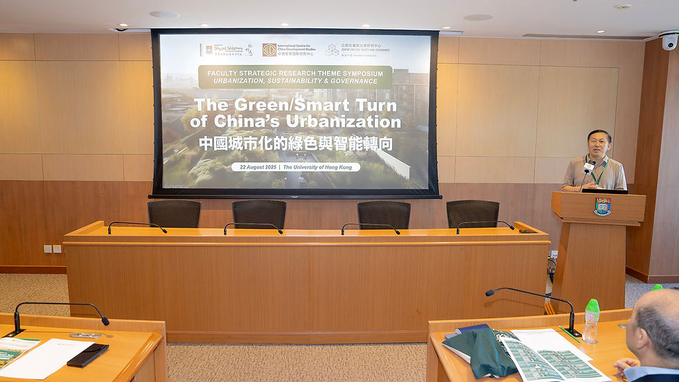 Speaker at podium in a lecture room, with symposium slide reading The Green/Smart Turn of China’s Urbanization at HKU.