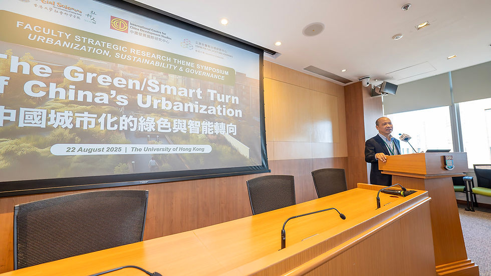 Man at podium in conference room speaks beside slide: The Green/Smart Turn of China’s Urbanization, University of Hong Kong.
