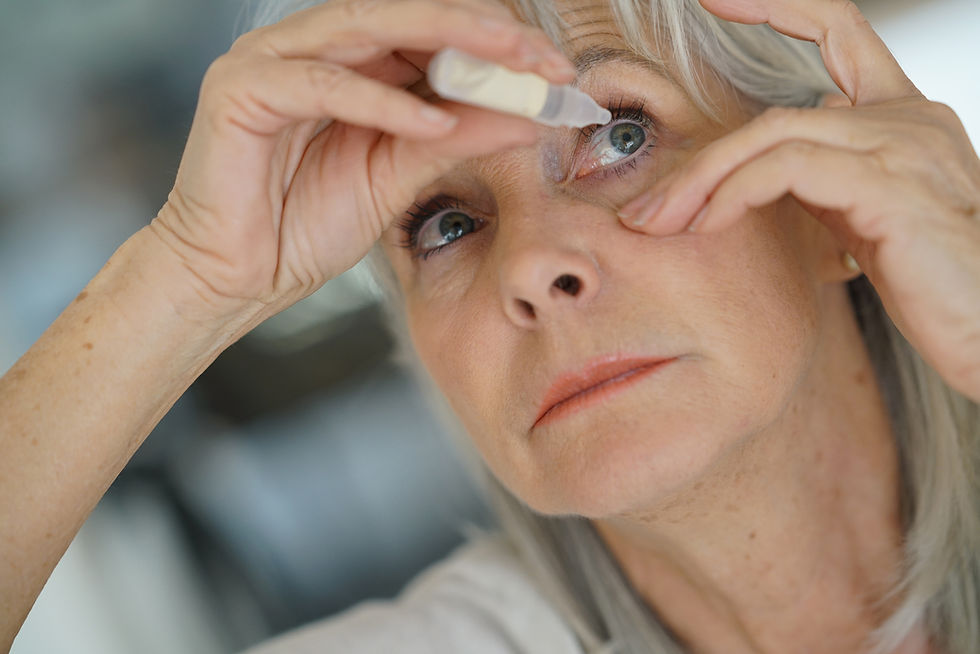 Senior woman putting eye drop .jpg