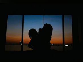 Silhouette of Amy and Sophie sharing an intimate moment with the Bangkok sunset glowing behind them in Shades Season 1.