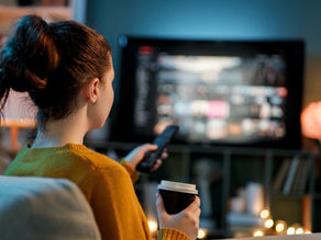 Woman watching streaming content at home, reflecting how fans are keeping up with the rapid growth of Thai GL series.
