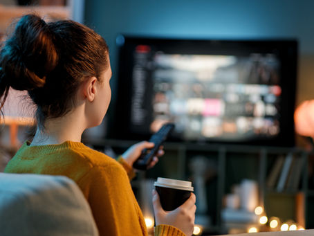 Woman watching streaming content at home, reflecting how fans are keeping up with the rapid growth of Thai GL series.