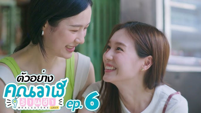 Wan and Maewnam giggle while painting together, sharing a soft, playful moment as they lock eyes mid-project—sapphic joy in full effect.