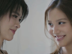 Key smiles at Chan as she officially introduces Chan to her family as her girlfriend in Moonshadow Episode 8.