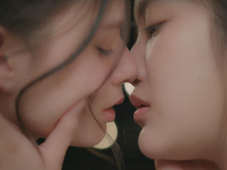 Lom and Princess Blew lean in for an intimate kiss under the night sky, faces close as Princess Blew, drunk and emotional, imagines a romantic moment between them in The Air EP5.