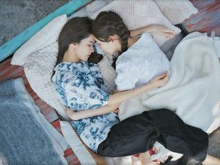 Fai wraps her arms and legs around Kaphrao as they sleep together after Fai's drunken night in Episode 4 of The Fire.
