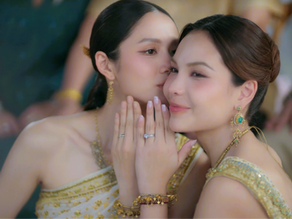 Klao and Si smiling during their traditional Thai wedding ceremony in Hometown Romance EP7, sharing a joyful moment as newlyweds.